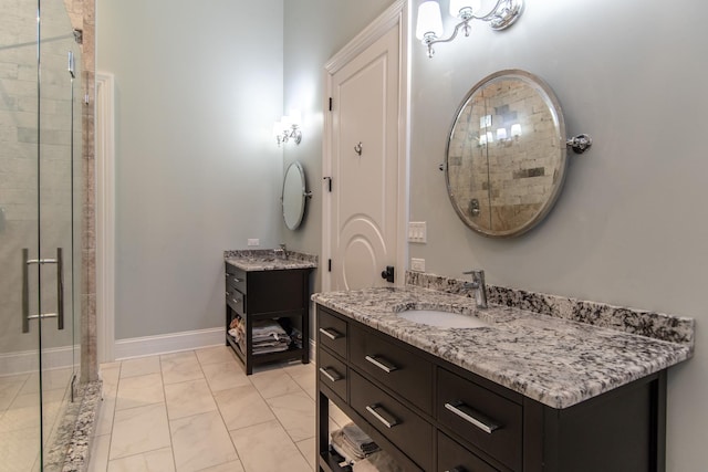 bathroom with a sink, baseboards, two vanities, and a stall shower