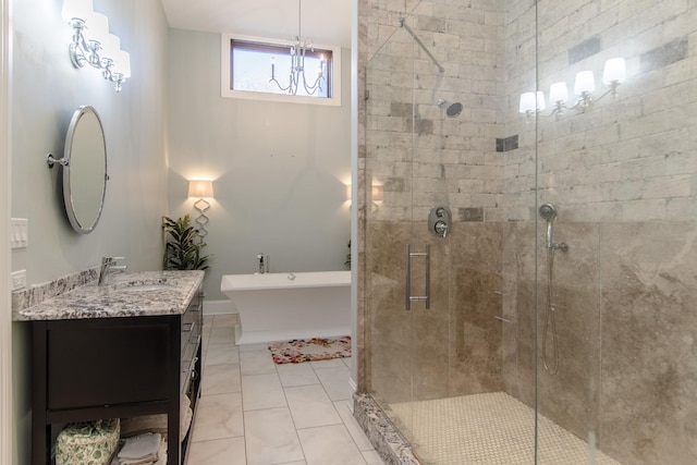 full bathroom featuring a chandelier, a freestanding bath, a stall shower, and vanity