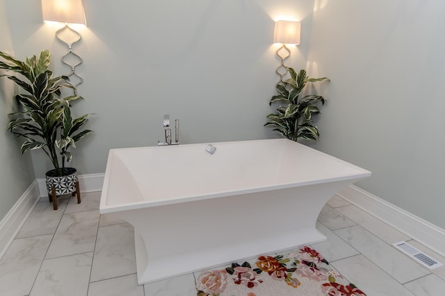 full bathroom with a soaking tub, visible vents, marble finish floor, and baseboards