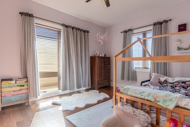 bedroom with a ceiling fan and wood finished floors