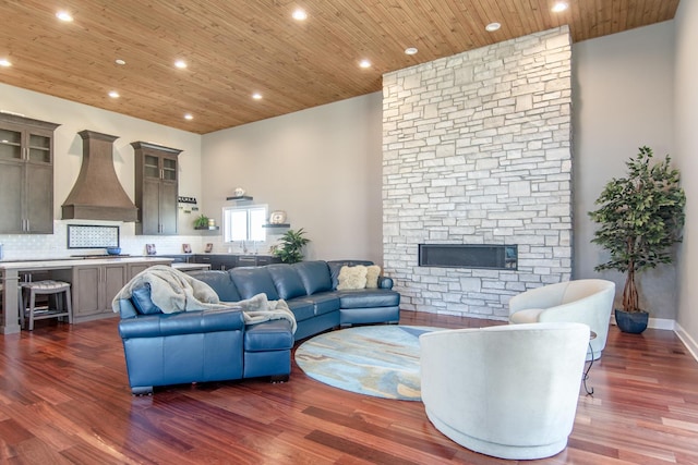 living room with recessed lighting, a fireplace, wooden ceiling, and dark wood-style flooring