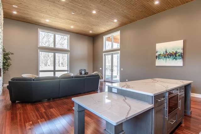 kitchen with open floor plan, dark wood-type flooring, and wooden ceiling