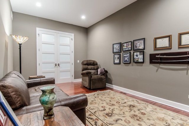 living area with recessed lighting, baseboards, and wood finished floors