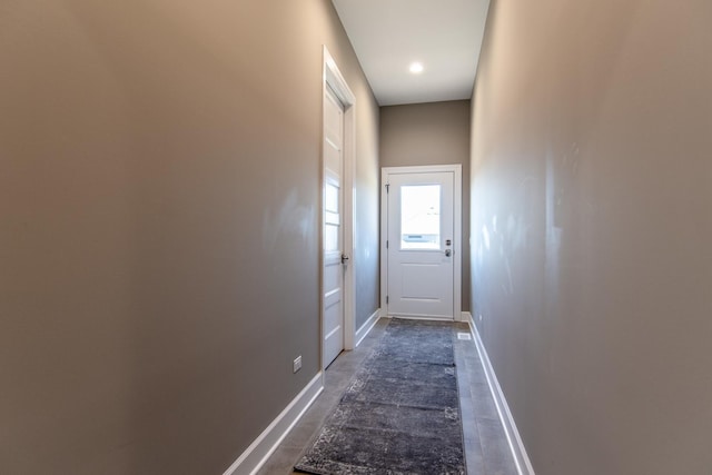 doorway featuring baseboards