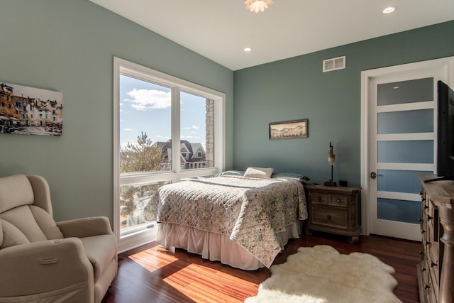 bedroom with dark wood-type flooring, recessed lighting, and visible vents