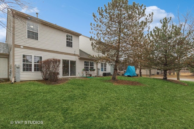 rear view of house with a lawn