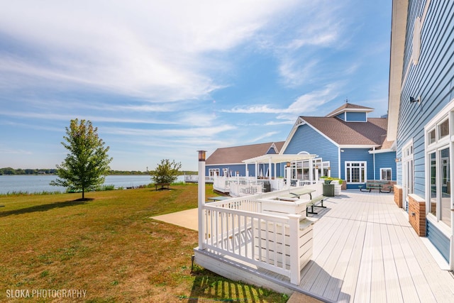 wooden deck featuring a water view and a yard