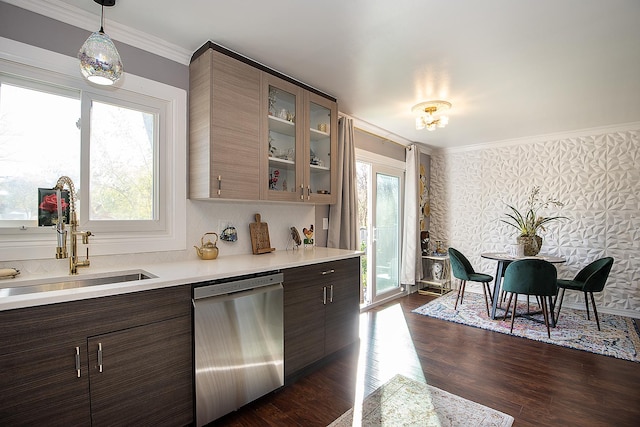 kitchen featuring glass insert cabinets, ornamental molding, light countertops, stainless steel dishwasher, and a sink