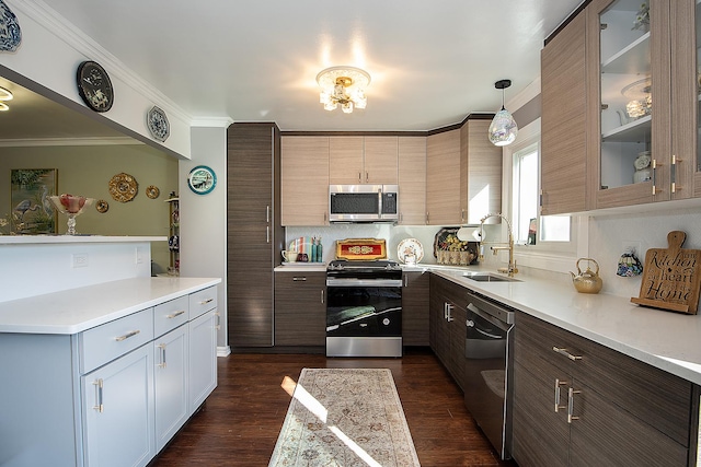 kitchen with crown molding, stainless steel appliances, light countertops, glass insert cabinets, and a sink