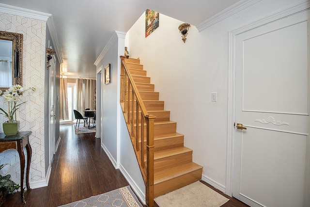 stairway featuring crown molding, baseboards, and wood finished floors