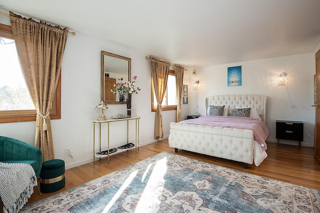 bedroom with wood finished floors and baseboards