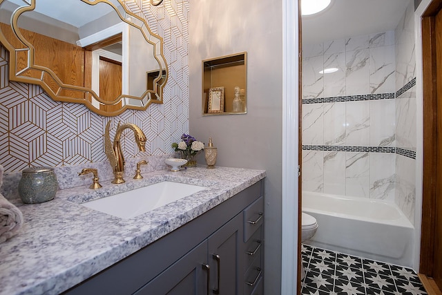 bathroom featuring toilet, bathing tub / shower combination, and vanity