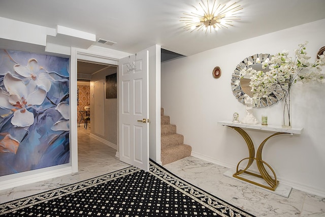 interior space with marble finish floor, baseboards, and visible vents