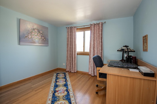 home office featuring baseboards and wood finished floors