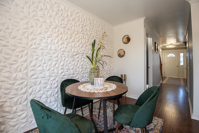 dining space with ornamental molding, hardwood / wood-style flooring, and baseboards