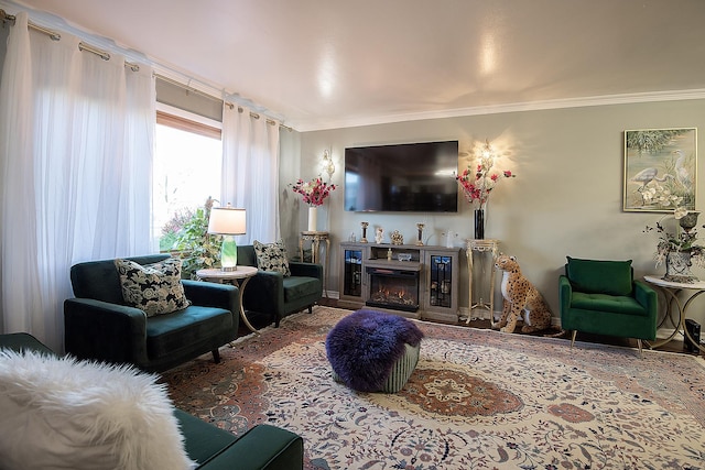 living room with ornamental molding and a glass covered fireplace