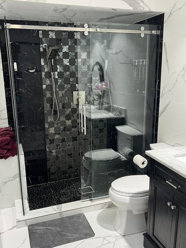 bathroom with toilet, marble finish floor, a shower stall, and vanity