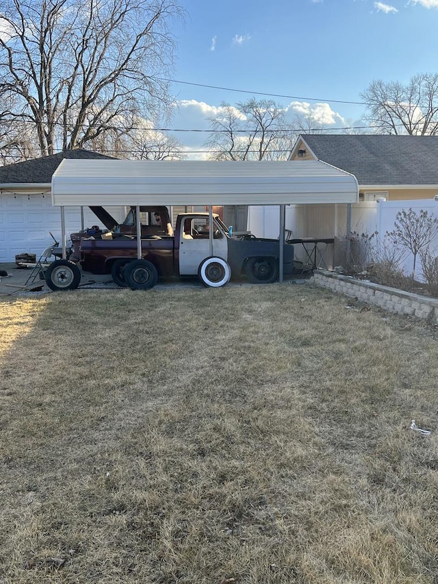 view of car parking featuring fence and a detached carport