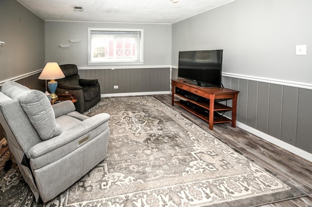 926 E Balsam Ln, Bartlett, IL 60103 - living area featuring wood finished floors, wainscoting, a textured ceiling, baseboards, and wooden walls
