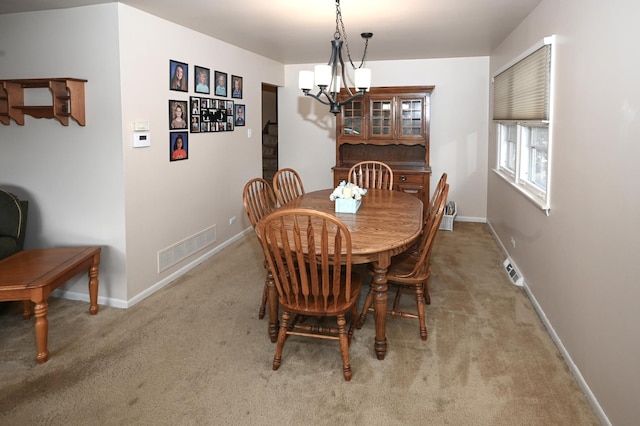 926 E Balsam Ln, Bartlett, IL 60103 - dining area featuring a chandelier, carpet flooring, and baseboards