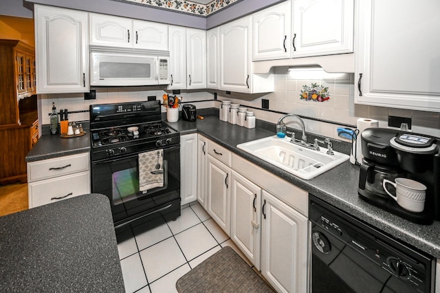 926 E Balsam Ln, Bartlett, IL 60103 - kitchen featuring black appliances, a sink, dark countertops, and white cabinetry