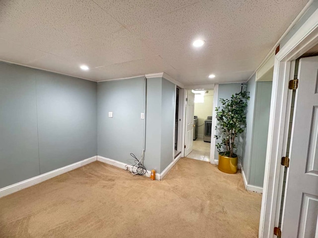 finished basement featuring washer / dryer, baseboards, a textured ceiling, carpet flooring, and recessed lighting