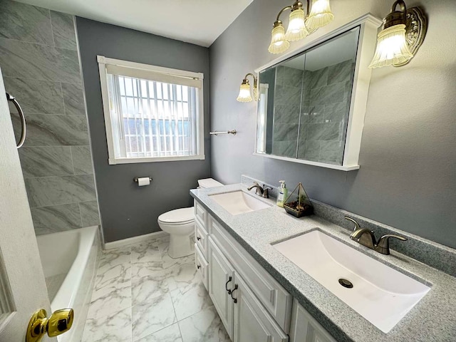 bathroom featuring marble finish floor, a sink, toilet, and baseboards