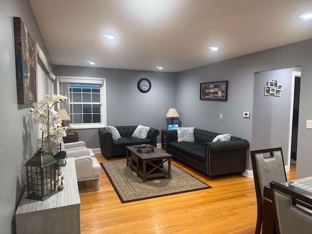 living room with recessed lighting, baseboards, and wood finished floors