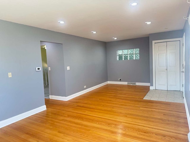 interior space featuring light wood-type flooring, visible vents, baseboards, and recessed lighting