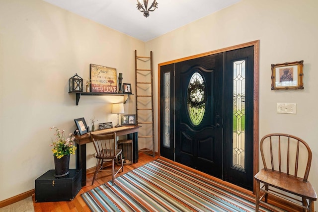 foyer entrance featuring baseboards and wood finished floors