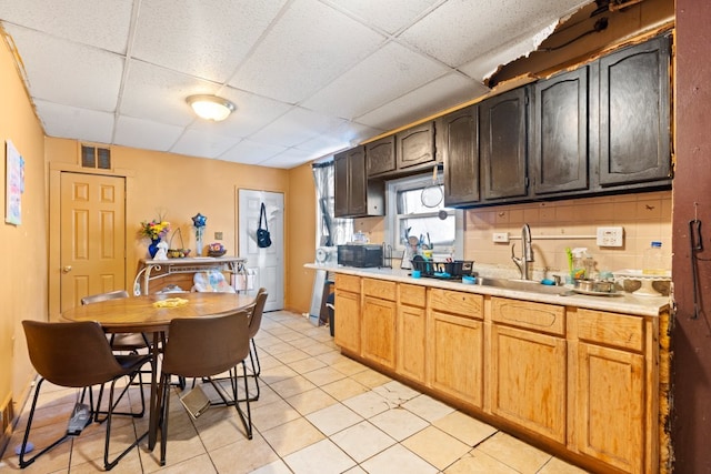 kitchen featuring light countertops, visible vents, and a drop ceiling