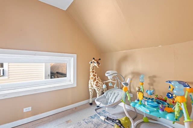 rec room with carpet, vaulted ceiling, and baseboards