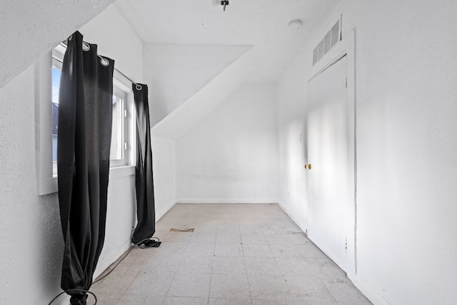 additional living space with lofted ceiling and visible vents