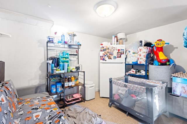 bedroom featuring tile patterned floors and freestanding refrigerator