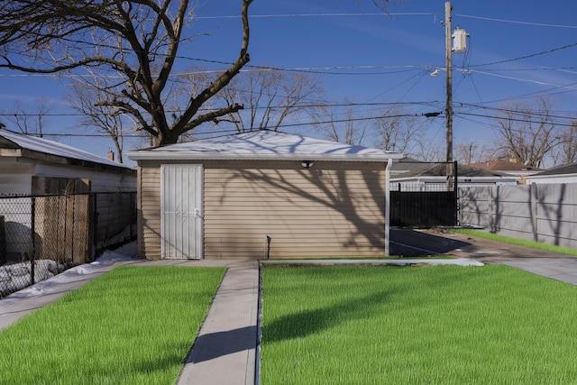 view of outbuilding featuring fence and an outbuilding