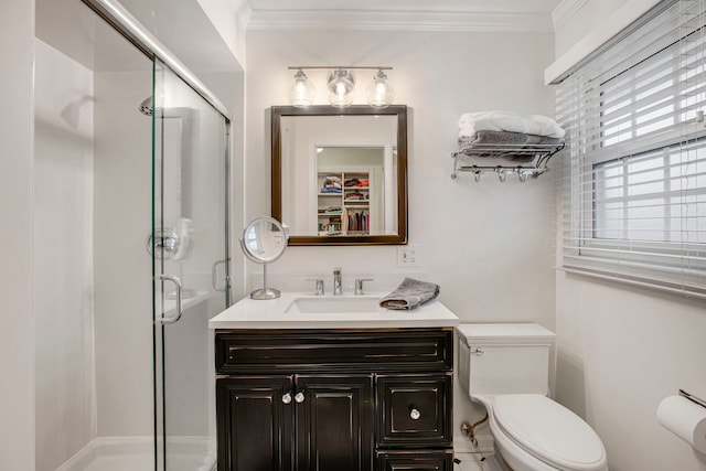 bathroom with ornamental molding, a shower stall, and toilet