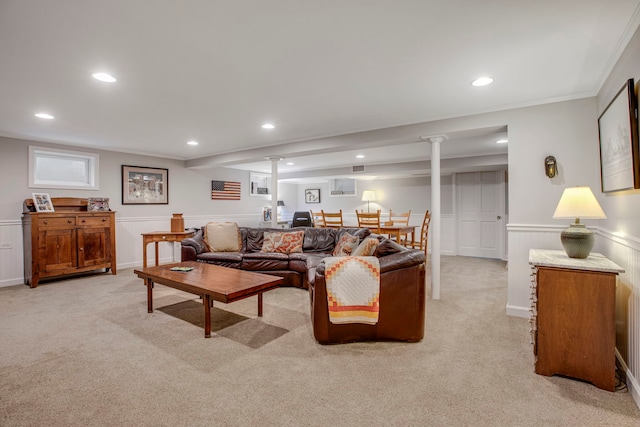living area featuring light carpet, a wainscoted wall, crown molding, and recessed lighting