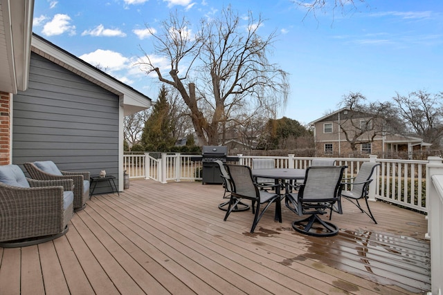 deck featuring outdoor dining area and area for grilling