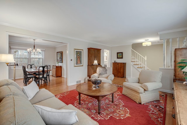 living room featuring crown molding, visible vents, stairway, light wood-type flooring, and baseboards
