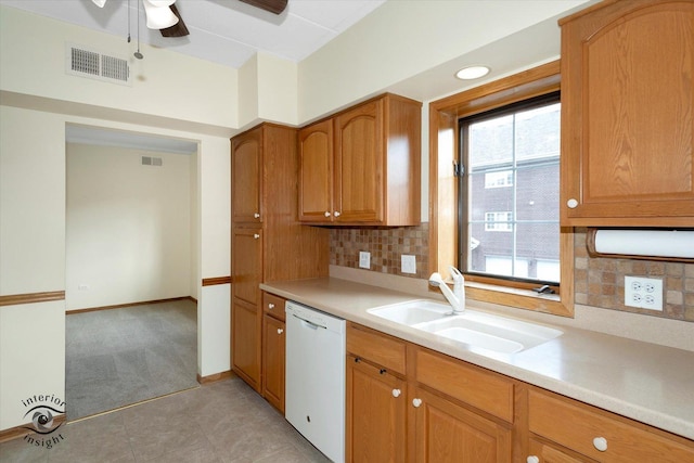 kitchen featuring a sink, visible vents, light countertops, and dishwasher