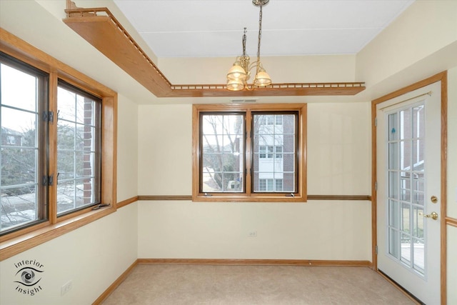 unfurnished dining area featuring plenty of natural light, visible vents, and baseboards