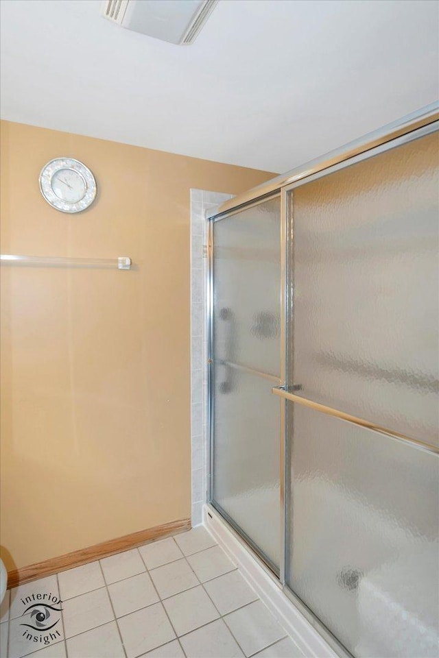 full bath featuring a stall shower, tile patterned flooring, visible vents, and baseboards