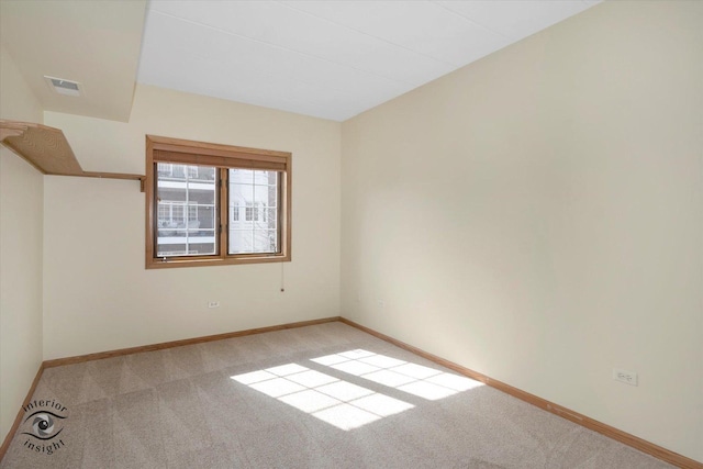 unfurnished room featuring carpet flooring, visible vents, and baseboards