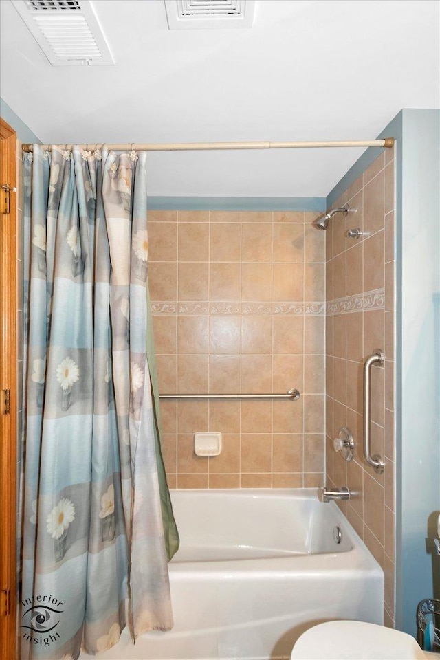 bathroom featuring toilet, visible vents, and shower / tub combo with curtain