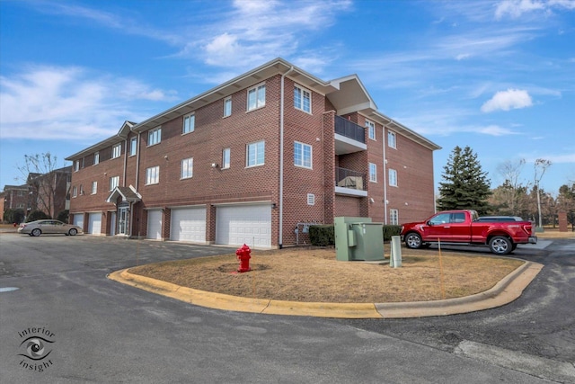 view of property with a garage and driveway