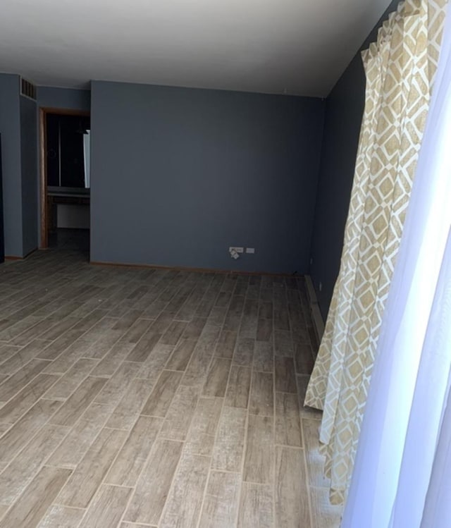 empty room featuring visible vents and wood finished floors