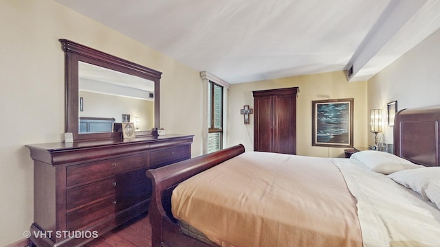 bedroom featuring visible vents and wood finished floors