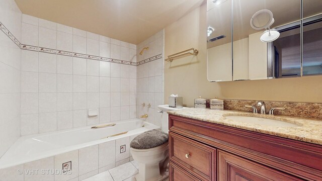 full bath with toilet, tiled shower / bath combo, vanity, and tile patterned floors