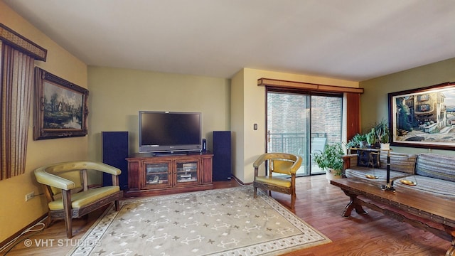 living area featuring baseboards and wood finished floors