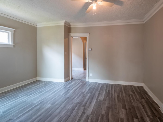 spare room with baseboards, a textured ceiling, ornamental molding, and wood finished floors